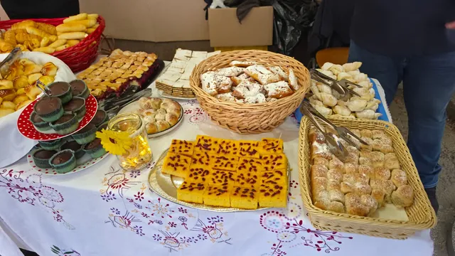 Slatki kolači, krafne i kiflice na ukrašenom stolu
