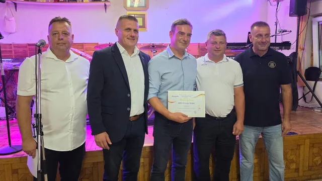 Dobitnik zlatne diplome s uzvanicima na pozornici