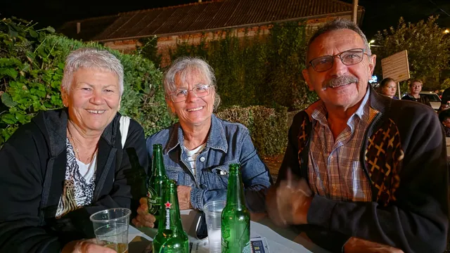 Troje gostiju uz pivo za stolom u noćnim satima